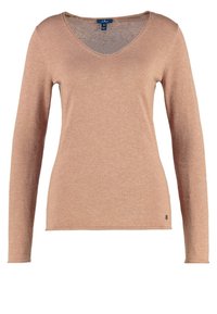 Långärmad V-ringad tröja i mjukt beige stickat material med en figurnära passform och liten logotypaccent på den nedre sidan.