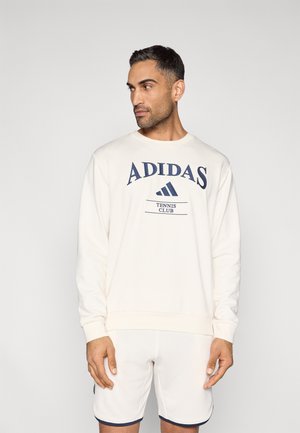 Weißes Sweatshirt aus Baumwolle mit dunkelblauem "ADIDAS TENNIS CLUB" Schriftzug und Logo auf der Vorderseite. Verfügt über einen Rundhalsausschnitt und gerippte Bündchen.