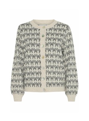 Cardigan crème avec motif de nœud noir, col rond, fermeture à boutons sur le devant et poignets côtelés. Texture douce avec une coupe décontractée.