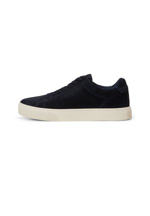 Niedriger schwarzer Wildleder-Sneaker mit schwarzen Schnürsenkeln und dicker weißer Gummisohle, von der Seite auf weißem Hintergrund gezeigt.