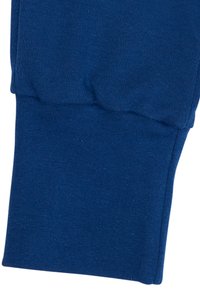 Navyblaue Baumwoll-Jogginghose mit elastischen Bündchen, die eine weiche Textur und ein geripptes Finish aufweist, sowie einer gerafften Naht für einen engen Sitz am Knöchel.