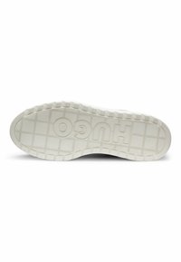Sole of a sneaker in light gray with textured grip patterns, featuring a prominent "HUGO" logo. Matte finish with a checkered design.