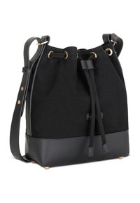 Sac bourse noir avec base en cuir et bandoulière réglable, équipé d'œillets dorés et d'une fermeture à cordon de serrage.