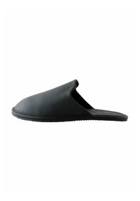 Black leather slip-on slipper with a rounded toe and textured finish. Features a flexible sole and minimalistic design.