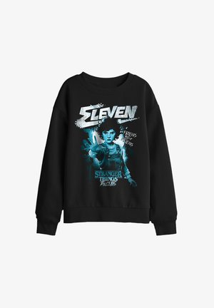 Black sweatshirt featuring Eleven from Stranger Things with outstretched hand, text "Eleven," "Friends Help Friends," and "Tales from 85."