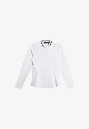 Valkoinen pitkähihainen paita vetoketjullisella kauluksella, jossa mustavalkoraidallinen kaula-aukko ja sileä, istuva muotoilu.