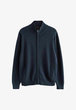 Jūras spēku zipsvars izgatavots no mīksta adīta auduma. Iespējas ietver ribotu apkakli, aproces un divas sānu kabatas papildu funkcionalitātei.