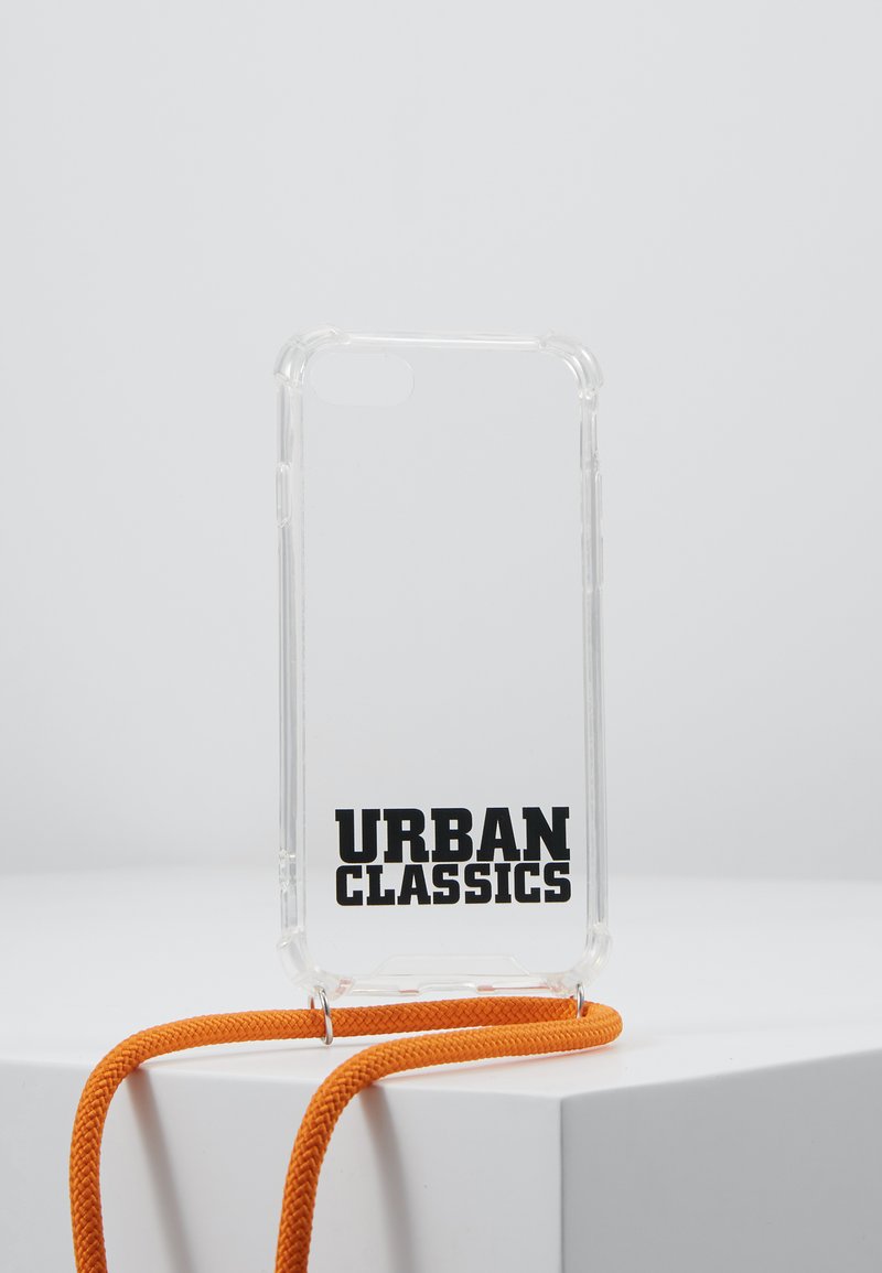 Transparent phone case with "URBAN CLASSICS" in bold black lettering; includes a bright orange lanyard for easy carrying.