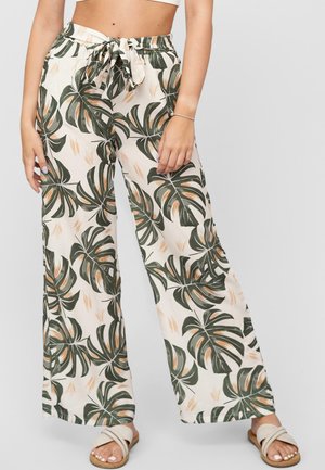 Wide-leg trousers made of light fabric, featuring a green and beige tropical leaf pattern. Comes with a drawstring waist and relaxed fit.