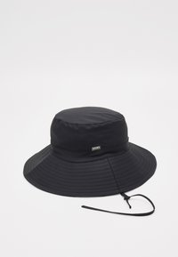 Black bucket hat made of waterproof fabric, featuring a wide brim, ribbed texture, and a tone-on-tone logo detail on the band.