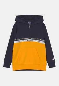 Sudadera con capucha en azul marino y amarillo, con cremallera, bolsillo frontal y bandas del logo de Champion en el pecho y la manga.