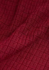Woven fabric in a deep red color with a textured grid pattern. The surface appears soft and features a slightly raised, patterned texture.