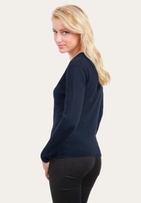 Pull à manches longues couleur bleu marine, au design ajusté, en tissu doux, avec un col rond et des détails de couture subtils.