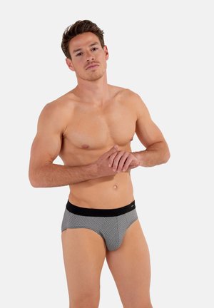 Grau gemusterte Slips mit einem schwarzen elastischen Bund, die eine glatte Textur und ein konturiertes Design für Unterstützung bieten.