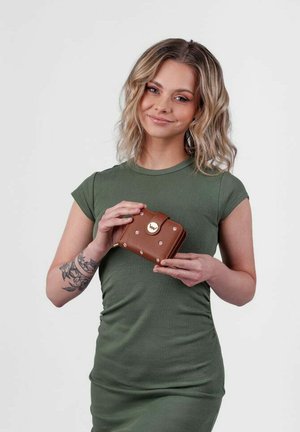 Brown leather wallet with gold hardware, featuring a dot pattern and clasp. Handheld, displayed against a neutral background.