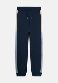 Jogging en bleu marine avec des panneaux latéraux beige et bleu clair, taille élastique avec cordon de serrage, et poignets côtelés.