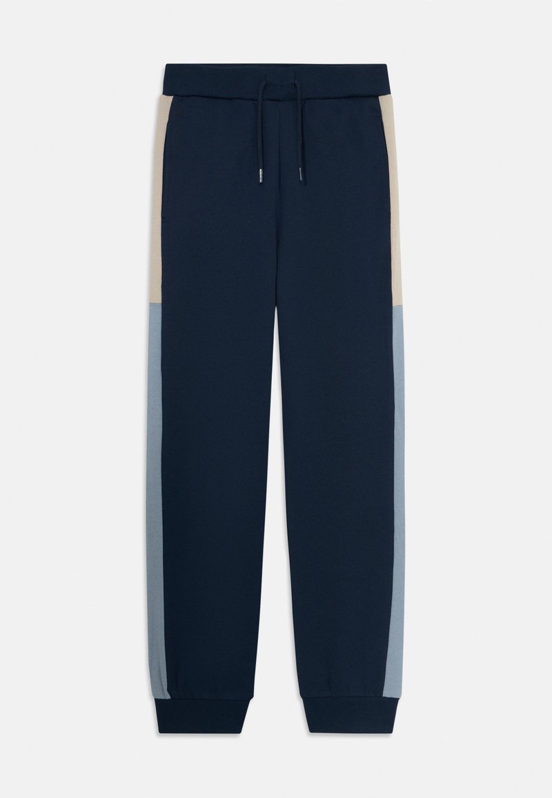 Jogging en bleu marine avec des panneaux latéraux beige et bleu clair, taille élastique avec cordon de serrage, et poignets côtelés.