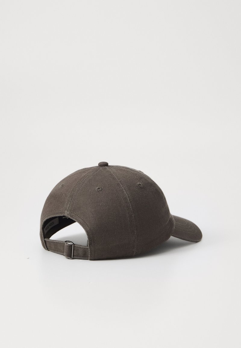 Brown cotton baseball cap with a curved brim, six-panel design, adjustable back strap, and visible stitching details.