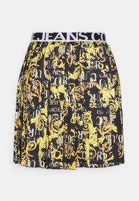 Svart kjol med veckad design, prydd med gula blommönster och fet text. Elastisk midja med "JEANS CO" i kontrasterande färg.