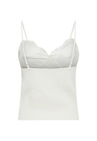 Balts bezroku īss tops ar mežģīņu apmalotiem kausiņiem un regulējamiem plāniem plecu siksnām uz vienkārša fona.