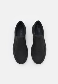Chaussures noires à enfiler en cuir lisse avec des panneaux élastiques sur les côtés. Dotées d'un bout arrondi et d'un logo discret sur la semelle intérieure.