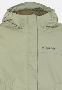 Light green Columbia jacket with a hood, front zipper covered by a storm flap, and elastic waist detailing.