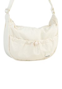 Crème-kleurige stoffen schoudertas met een zachte, afgeronde vorm, geraffineerde details, ritssluiting, verstelbare band en een subtiele logotag.