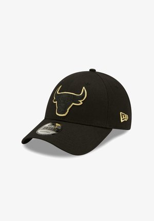 Black cap with curved visor, featuring a gold embroidered bull logo on the front and a New Era logo on the side. Adjustable design.