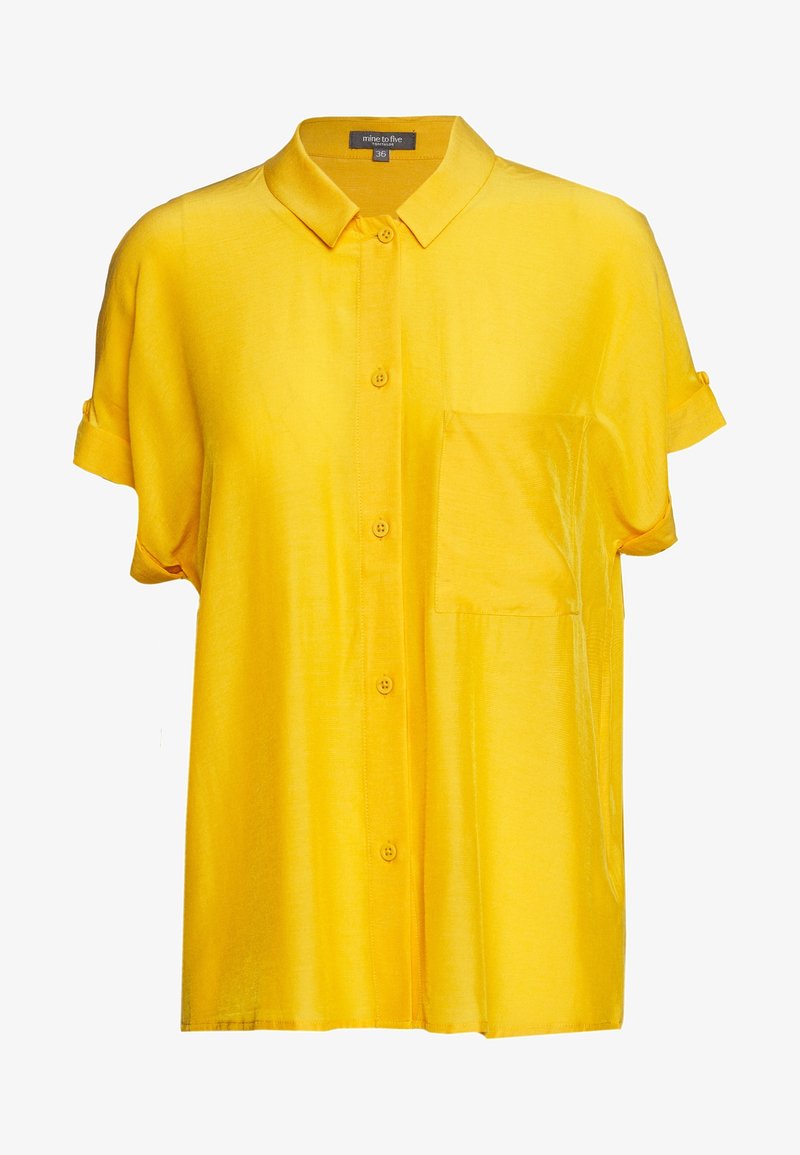 Chemise jaune à manches courtes avec boutons, col et poche poitrine, en tissu léger légèrement brillant, taille 36.