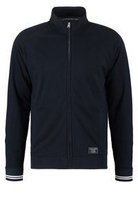 Giacca zip-up blu navy con colletto alto, polsini a coste con doppie strisce bianche, e una piccola patch del logo Abercrombie & Fitch nella parte inferiore anteriore.