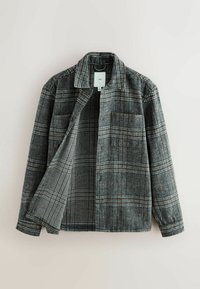 Gråternet jakke lavet af tekstureret stof, med knaplukning foran, to brystlommer og et klassisk krave-design.