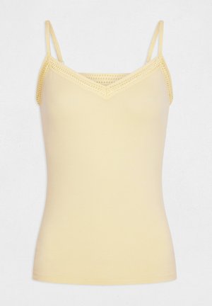 Camisole beige sans manches avec fines bretelles et détails en crochet le long de l'encolure en V et des bords.