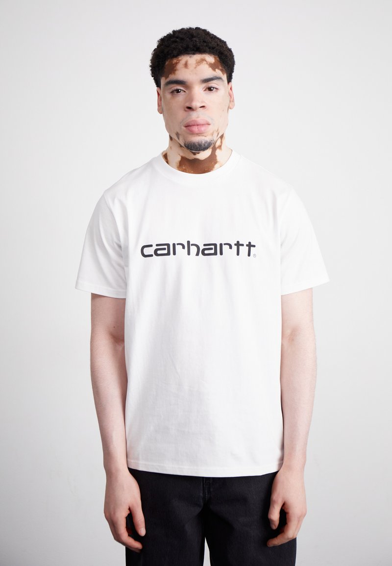 White cotton t-shirt with short sleeves, featuring a black "carhartt" logo in bold lettering across the chest. Simple, classic design.