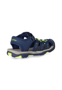 Marineblaue Sandalen mit einem strapazierfähigen Obermaterial aus Stoff, verstellbaren Riemen und einer grauen Gummisohle, die mit neon-grünen Akzenten und strukturierten Details versehen ist.