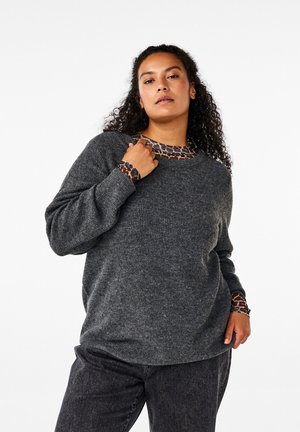 Gray, ribbed sweater with long sleeves, featuring a leopard print accent on the collar and cuffs, paired with dark gray pants.