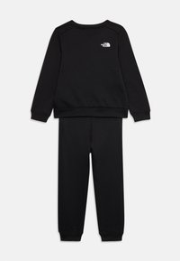 Ensemble sweat-shirt et pantalon noir en coton. Comprend des poignets et un ourlet côtelés, avec un petit logo blanc sur le haut du dos du sweat-shirt.