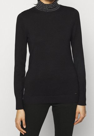 Black long-sleeve turtleneck sweater with a textured, embellished collar featuring small metallic studs. Smooth knit texture with ribbed hem.