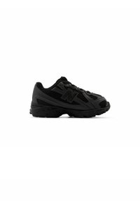 Black athletic shoe featuring a mesh upper, textured overlays, and a prominent logo on the side. Thick rubber sole with grip pattern.