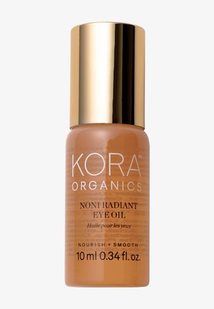 Glasflasche mit einem goldenen Deckel, enthält orangefarbenes Noni-Öl; das Etikett zeigt weißen Text "KORA ORGANICS NONI RADIANT EYE OIL", 10 ml Größe.