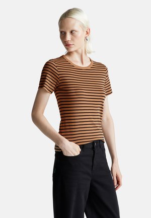 T-shirt a maniche corte a righe marroni con scollatura rotonda, realizzato in stoffa morbida. Abbinato a pantaloni neri con tasche laterali.