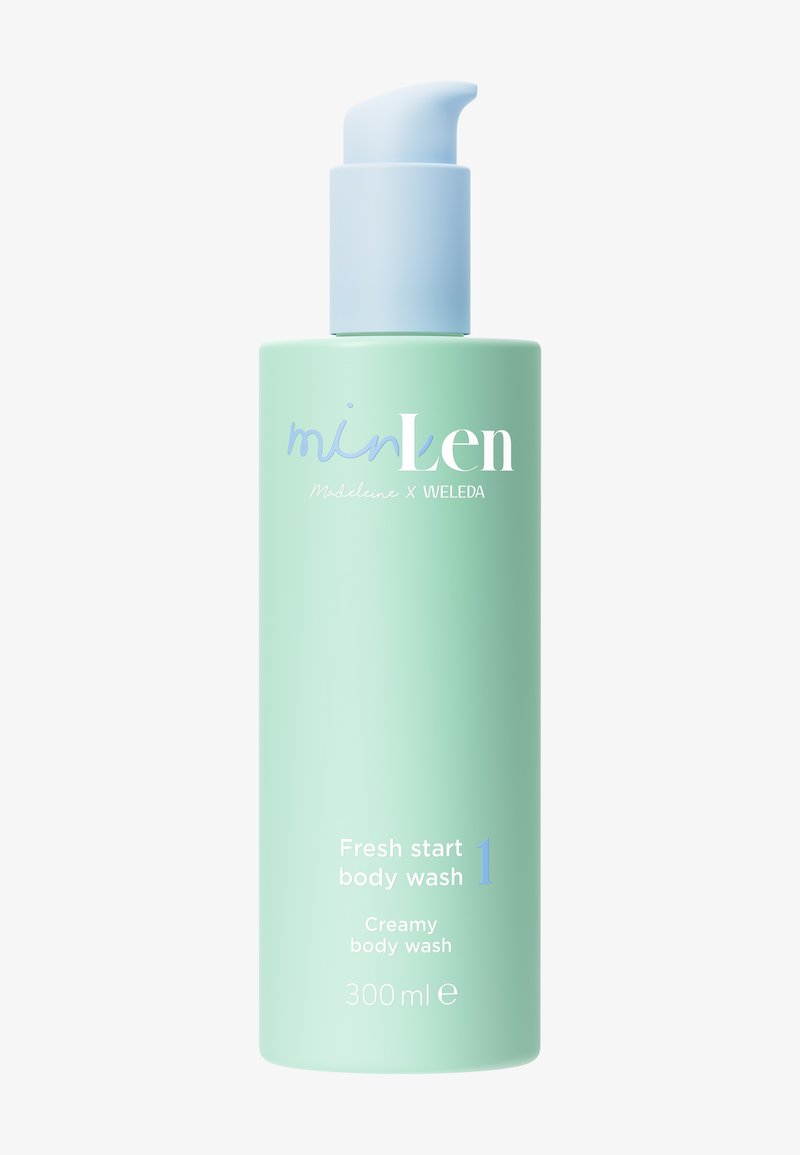 Bouteille vert menthe avec une pompe blanche étiquetée "minLen Fresh start body wash 300ml", un gel douche crémeux par Madeleine x Weleda.