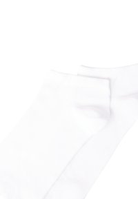 White cotton ankle socks featuring a simple design, smooth texture, and a fitted shape for comfort. No patterns or embellishments.