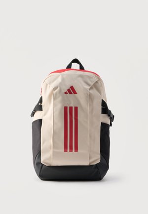 Beige und schwarzer Rucksack mit rotem Reißverschluss oben, drei senkrechten roten Streifen und einem roten dreieckigen Logo auf der Vorderseite.
