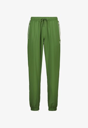 Pantalons de sport verts avec une taille élastique, un cordon de serrage ajustable, des poches zippées sur les côtés et des poignets fuselés. Tissu lisse et léger.