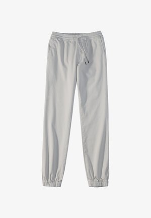Hellgraue Jogginghose mit elastischem Bund, Kordelzugverschluss, seitlichen Taschen und gerafften Bündchen an den Knöcheln. Weiches Textilmaterial.