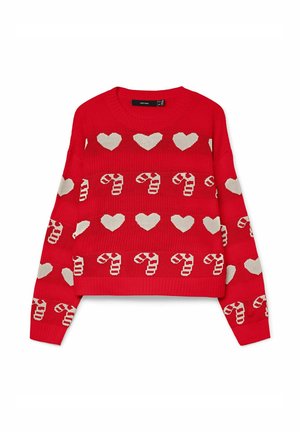 Rdeča pletena pulover s belimi srci in vzorci bonbonov urejenimi v vodoravnih črtah.
