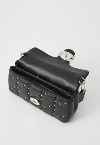 Black leather handbag featuring quilted design, silver accents, magnetic closure, and a shoulder strap. Interior is lined with fabric.