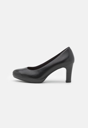 Black patent leather high heel pump with rounded toe, smooth texture, and a mid-height block heel.