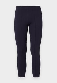 Mörkblå leggings tillverkade av elastiskt material, med hög midja och en åtsittande silhuett med synliga sömmar genom hela plagget.