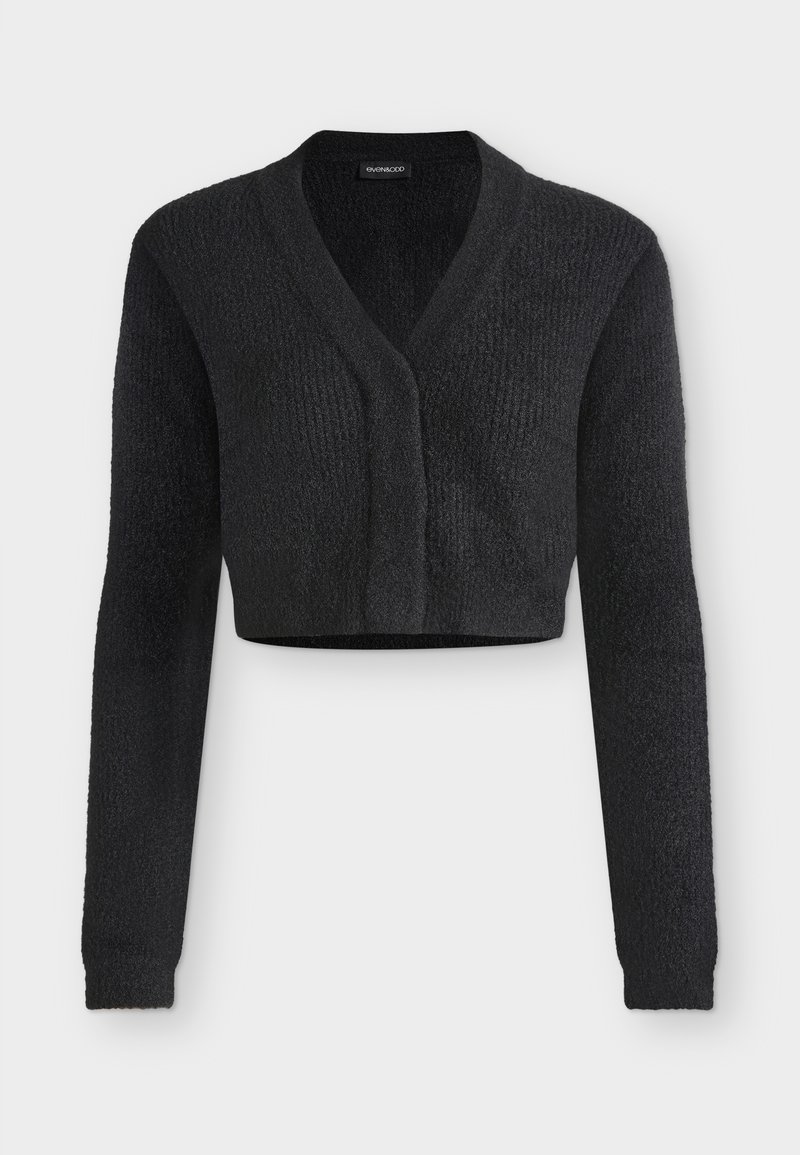 Cardigan court en maille noire avec manches longues et col en V, présenté sur un fond clair uni.